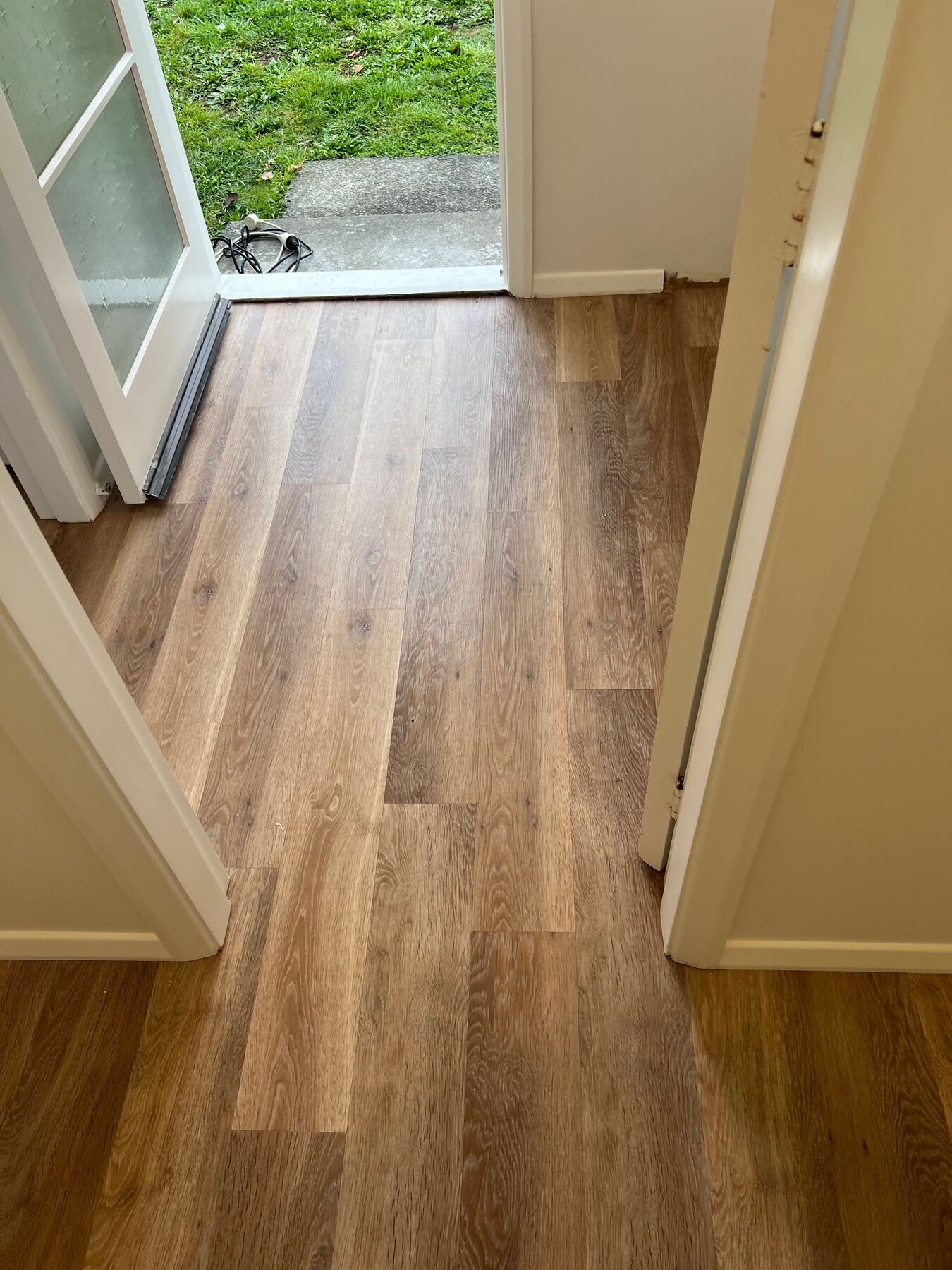 Timber-look flooring laid through a doorway